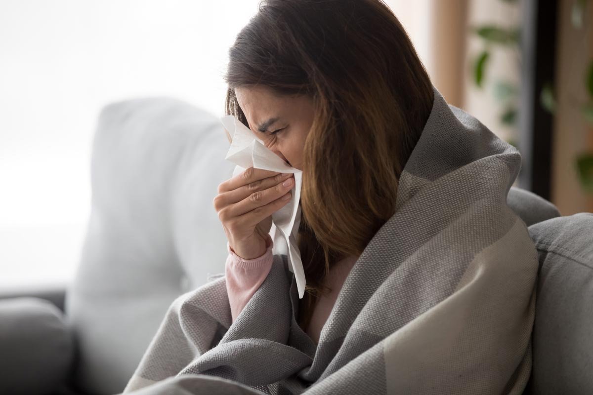 Young woman ill with cold symptoms